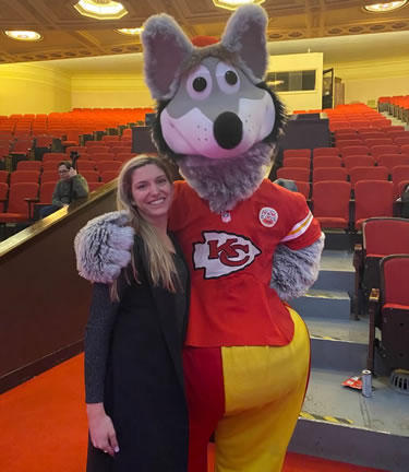 Angela Murphy posing for a picture with the Kansas City Chiefs mascot