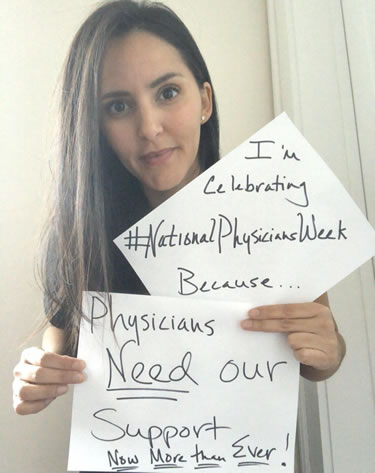 Dr. Leah Houston holding national physician week signs