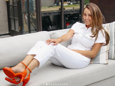 Haley Pavone smiling on couch with orange high heels