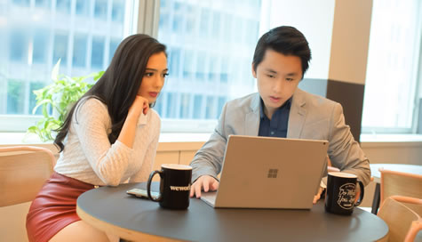 Hala Taha and Tim Tan working at laptop