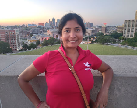 Nidhi Gupta with the Kansas City skyline behind her