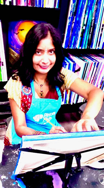 Nidhi Gupta painting in traditional Indian attire