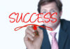 Creating Highly Successful Habits man writing 'success' showing highly successful