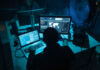 computer hackers in underground dark room