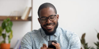 How Text Works Through Work-From-Anywhere Messaging Clutter smiling african-american texting on his mobile phone