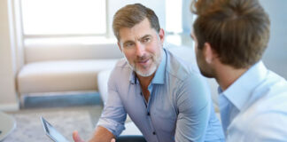 How ‘Big Guy/Little Guy’ Collaboration is the Ticket to Growth two men discussing a ticket to growth on a couch