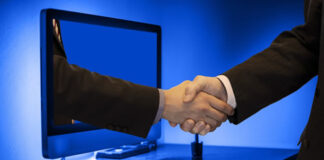 SaaS Needs ‘Big Guy-Little Guy’ Partnership to ROCKiT Growth Two men handshaking through a PC monitor for SaaS needs