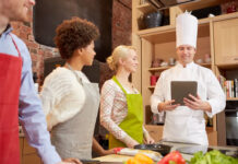 Consumer-centric Design Innovates the Future of Smart Tech 4 chefs in kitchen monitoring their culinary with technology