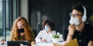 Pandemic-proof Campuses? How Technology is Helping college students in classroom with masks on