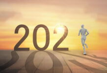 year 2021 with robot running towards sunset horizon