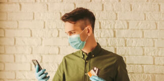 How COVID-19 Has Accelerated eCommerce Adoption man ordering online with mobile phone and holding credit cards