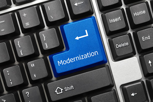 PC keyboard with blue enter key with modernization word