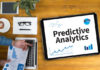 top-down view of man at desk with tablet that says predictive analytics