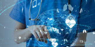 Smart Technology for Critical Healthcare healthcare provider holding tablet with digital IoT images floating above the tablet