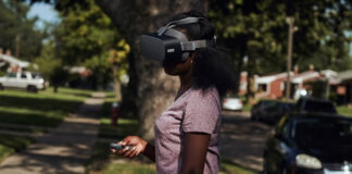 teenage girl outside using virtual reality headset