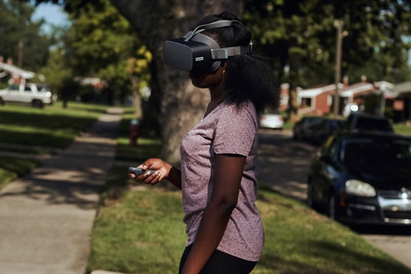 teenage girl outside using virtual reality headset