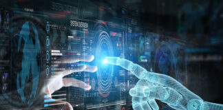 Why A Lack of Data Scientists Could Save AI human hand and ai hand touching index fingers through a digital dashboard