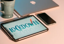 When Plans Change: Lessons for Business Leaders from the Pandemic laptop, tablet, and cell phone on a desk with coffee cup displaying the words lockdown