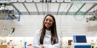 engineer girl in lab with arms crossed and smiling
