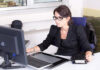 woman executive at her desk handling tasks on her computer