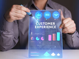 young man holding up a digital and virtual dashboard with the words customer experience