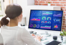 girl working at desk looking at cloud SaaS dashboards