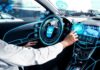 Connected Vehicles: Going for the Gold man in autonomous vehicle and pressing a button on a digital screen