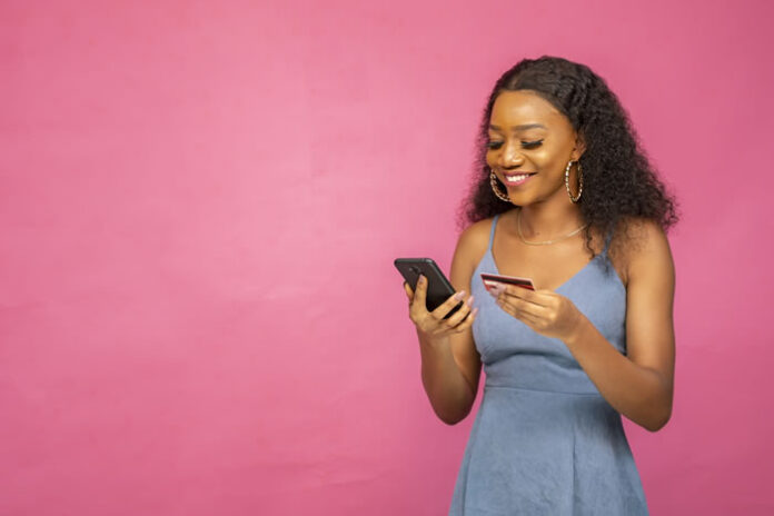smiling woman using her mobile phone for ecommerce online
