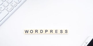 Best Managed WordPress Hosting Comparison WordPress in Scrabble game letters on a desk with a keyboard and cell phone