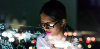 How to Keep from Drowning in an Ocean of Data woman looking at a virtual analytics dashboard in holograph form