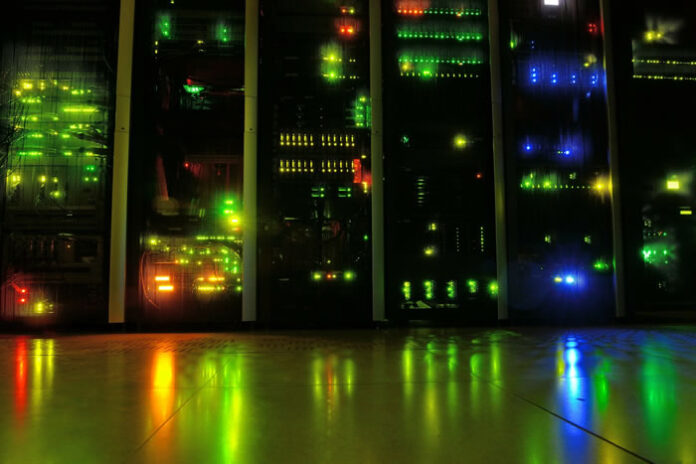darkened data center showing server infrastructure with many led lights