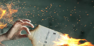 woman holding a paper that is on fire signifying the cost of paper