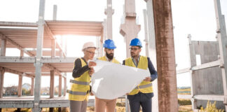 How to Successfully Market a Construction Technology Startup Firm three construction engineers looking at plans working in construction technology startup firm