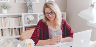 Key Signs You Should Take Your Side Hustle to the Next Level woman working from home on her laptop as her side hustle