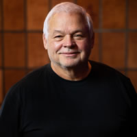 Headshot of Founder and CEO John Acres
