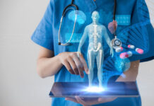 physician holding a tablet displaying a 3d image of human body