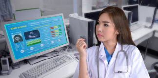 female medical provider looking at electronic health system
