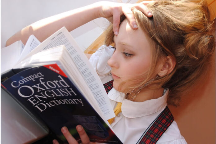 girl intently reading a book in her quest for continual learning