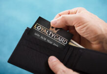man pulling loyalty program card from his wallet