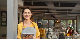 Human Behavior and the Future of Indoor Dining Together smiling restaurant owner with tablet using smart tech innovation