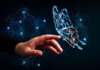 human hand reaching out to a digital butterfly representing digital transformation