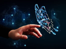 human hand reaching out to a digital butterfly representing digital transformation