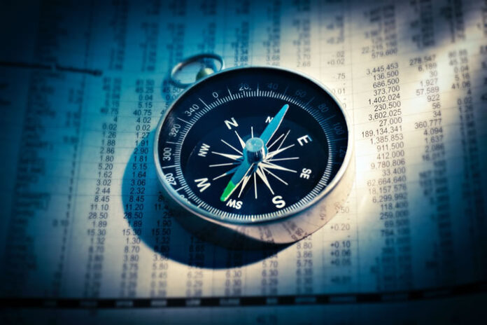 compass sitting on a financial planning document
