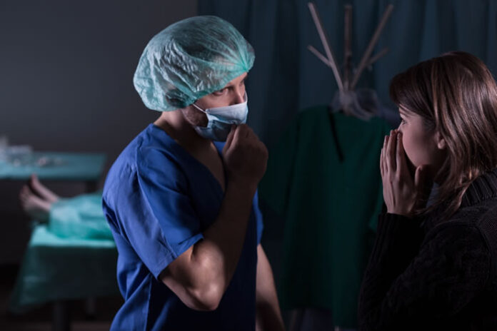 surgeon speaking with family member of patient