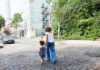 How Technology Can Bring Neighbors Together woman and toddler walking in their neighborhood