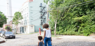 How Technology Can Bring Neighbors Together woman and toddler walking in their neighborhood