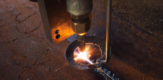 Everything You Need To Know About Plasma Cutting Plasma cutting machine actively cutting through iron