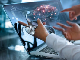 physicians reviewing laptop with healthcare technology