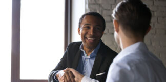 Sell Your Business Now, or When You Retire? The Answer Might be Yes two men handshaking after selling their business