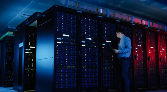 AWS vs GCP vs Azure: Which Cloud Computing Platform Wins? engineer inspecting rows of server cabinets in the cloud